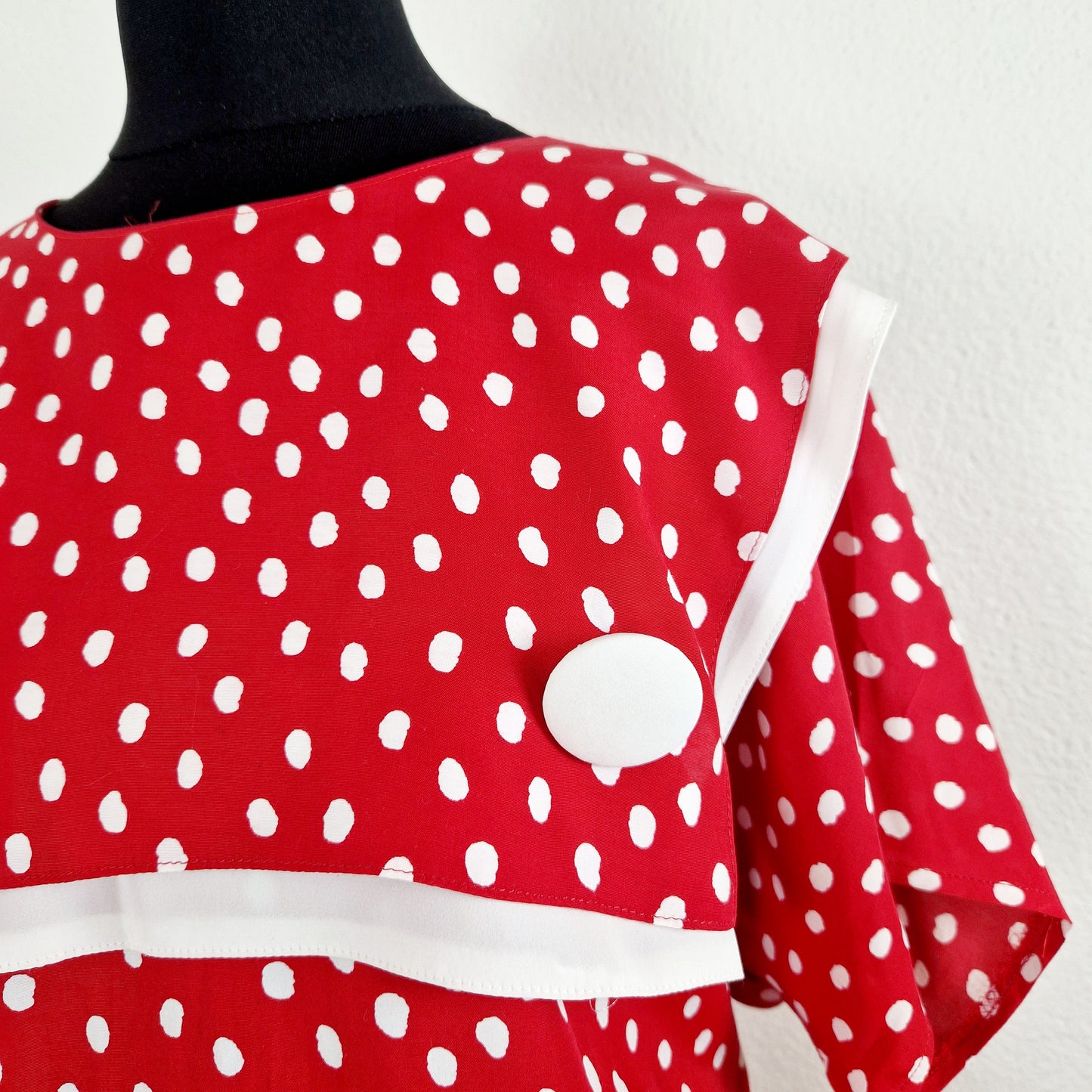 Einzigartiges und nachhaltiges Vintage Kleid, Kurzarm, in rot-weiss, mit Punkten. Unique and sustainable vintage dress, short sleeved, in red-white, with polka dots. Close-up.