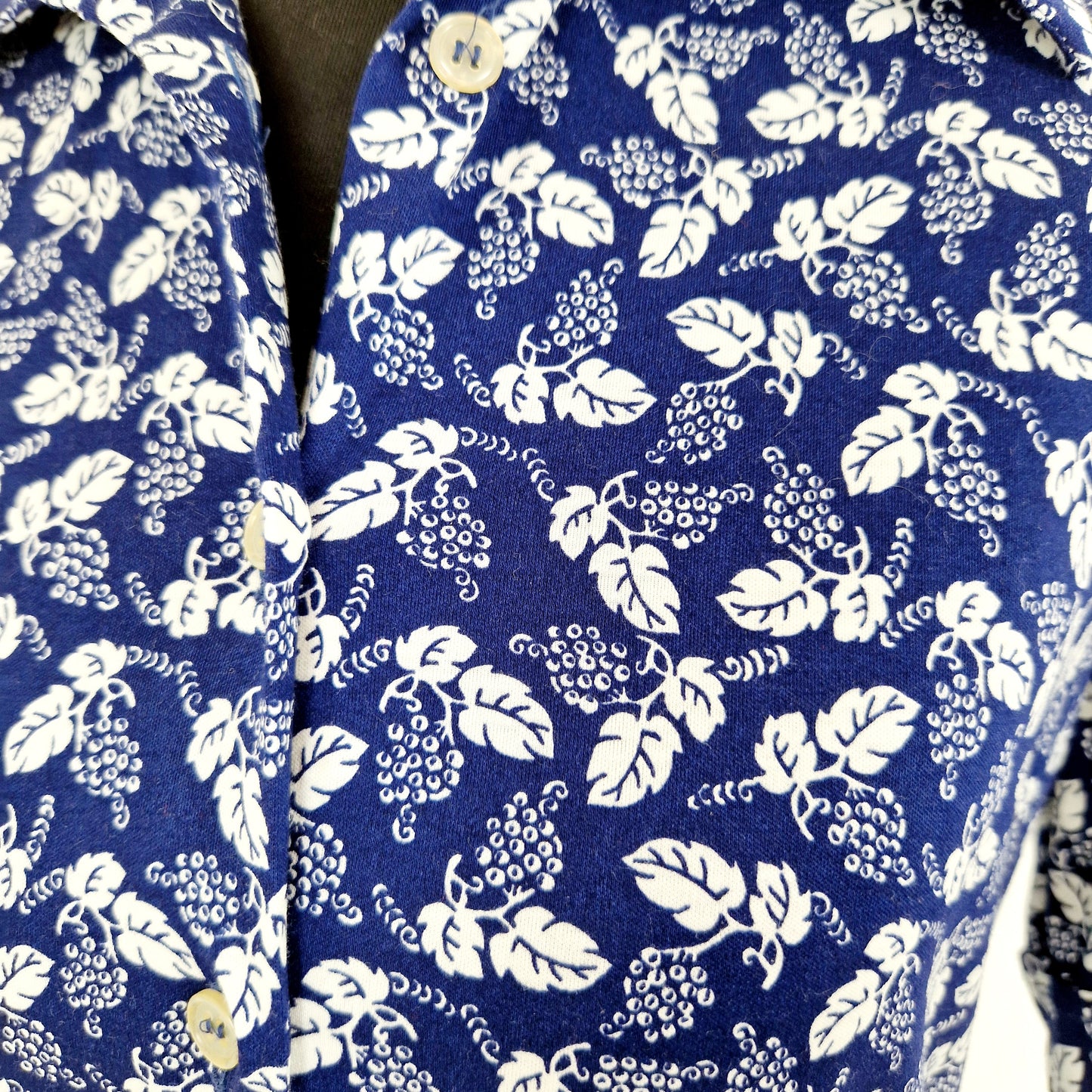 Einzigartige und nachhaltige Vintage Bluse in blau-weiss mit Blumen. Unique and sustainable vintage blouse in blue-white with flowers. Close-up.