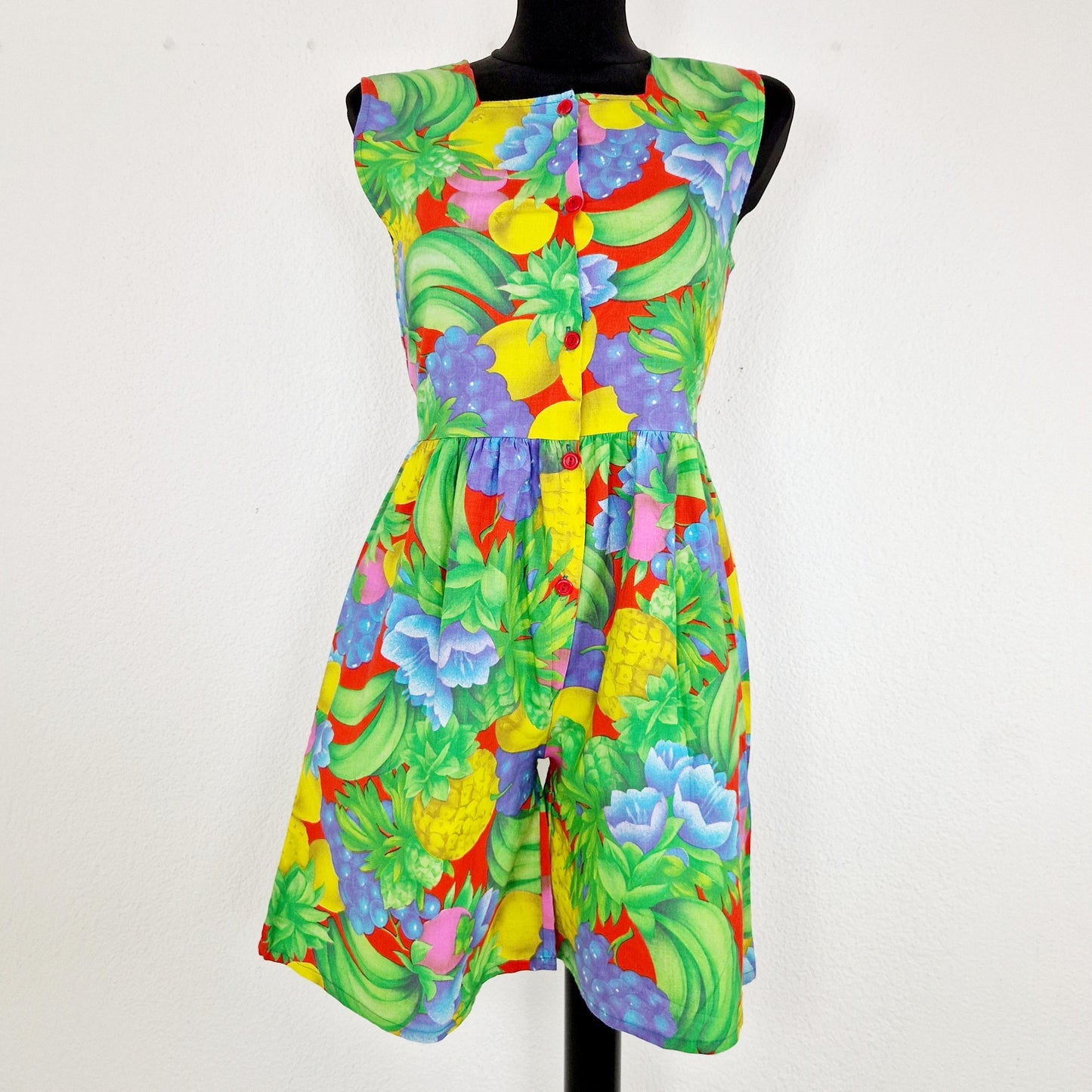 Einzigartiger und nachhaltiger Vintage Jumpsuit in hellgrün-blau-gelb mit Früchten. Unique and sustainable vintage jumpsuit in light green-blue-yellow. Front.