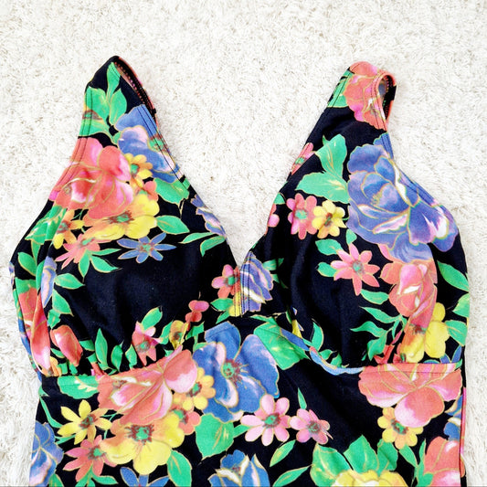 Einzigartiger und nachhaltiger Vintage Badeanzug in schwarz-gelb-rosa mit Blumen. Close-up.