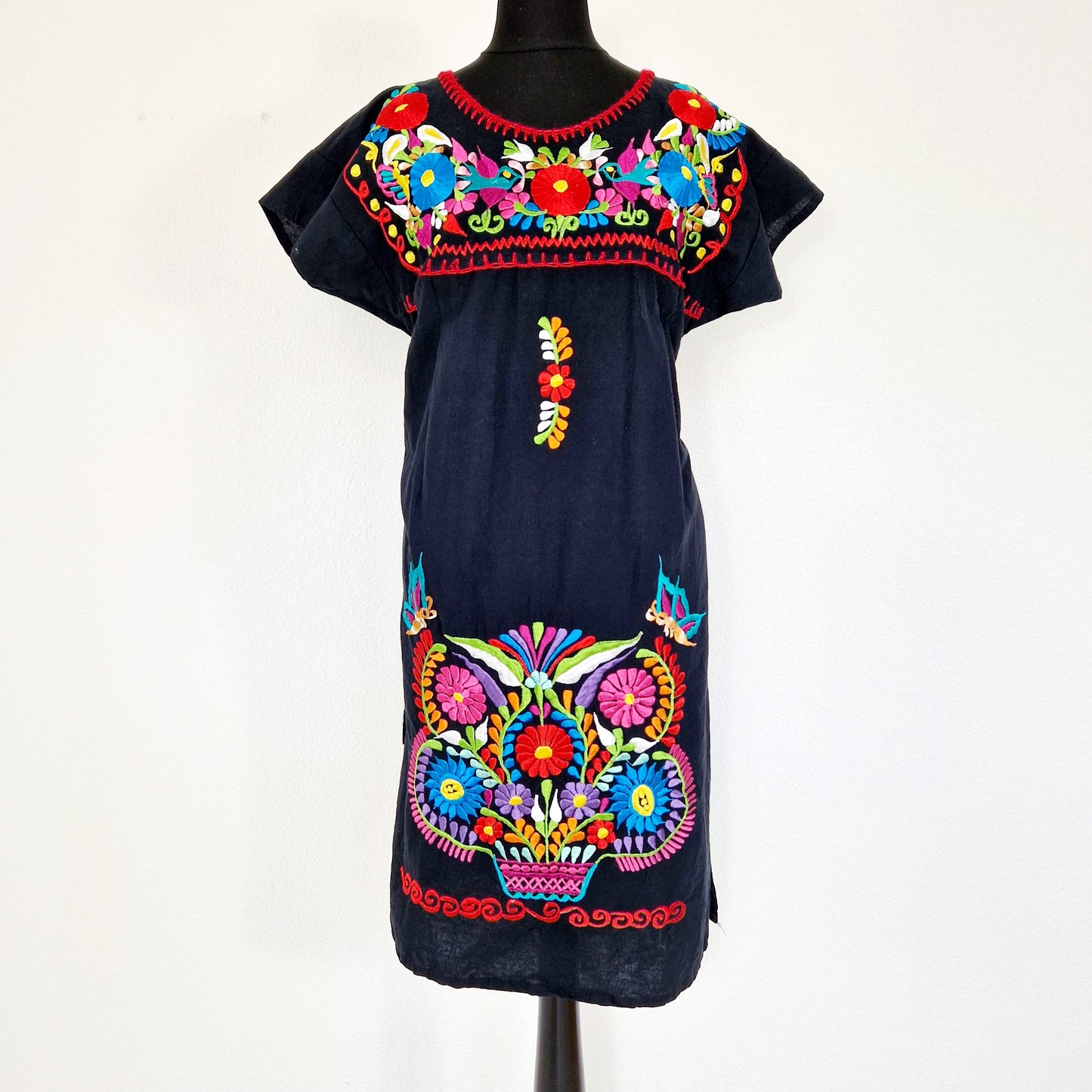 Einzigartiges und nachhaltiges Vintage Kleid in schwarz mit bunten Stickereien. Unique and sustainable vintage dress in black with colorful embroidery. Front.