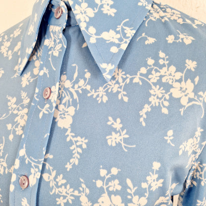 Einzigartige und nachhaltige Vintage Bluse in hellblau mit Blumen. Unique and sustainable vintage blouse in light blue with flowers. Close-up.