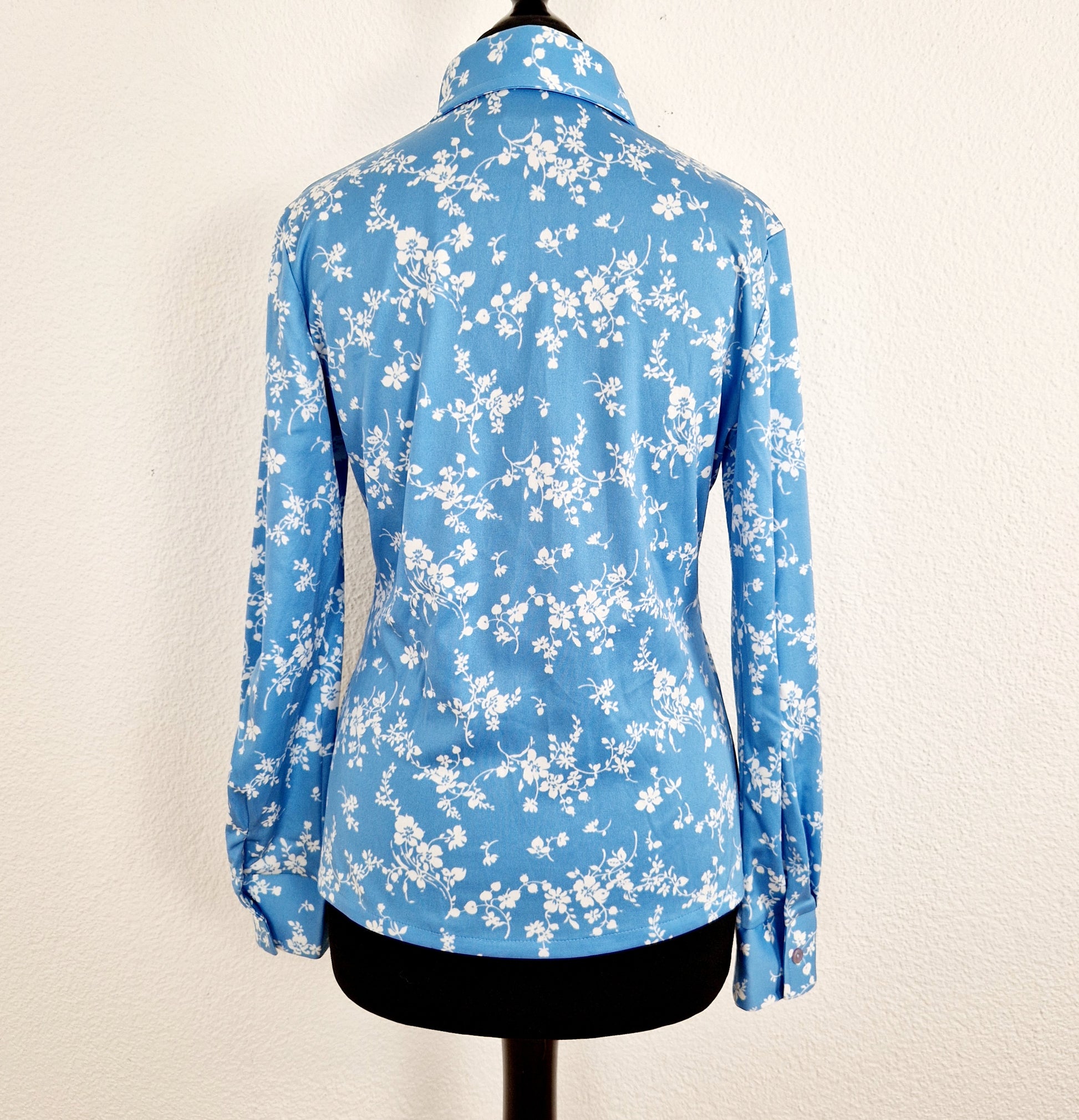 Einzigartige und nachhaltige Vintage Bluse in hellblau mit Blumen. Unique and sustainable vintage blouse in light blue with flowers. Back.