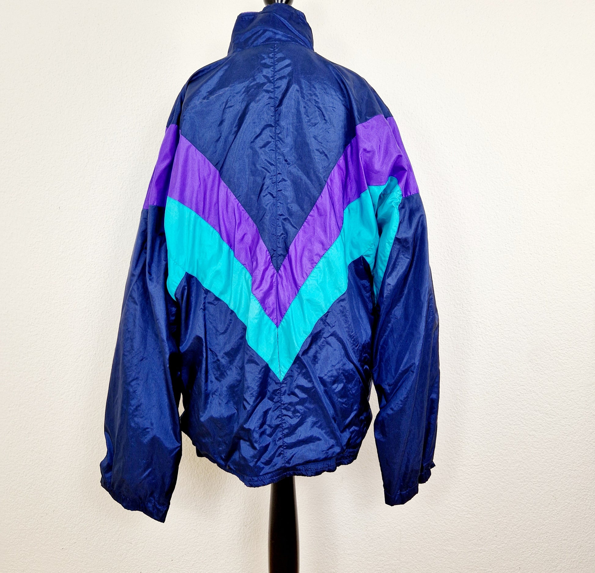 Einzigartige und nachhaltige Vintage Trainerjacke in dunkelblau-türkis-violett. Unique and sustainable vintage track jacket in dark blue-turquois-purple. Back.