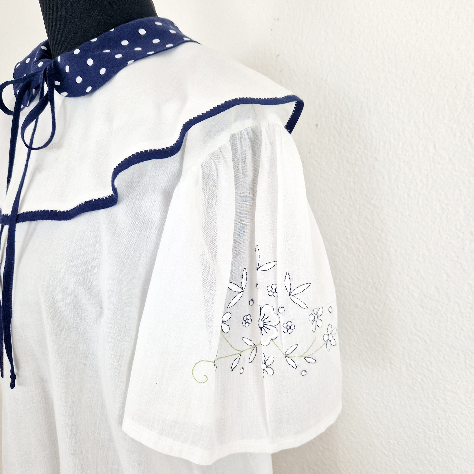 Einzigartige und nachhaltige Vintage Bluse in weiss-blau mit Kragen und Schleife. Unique and sustainable vintage blouse in white-blue with collar and bow. Sleeve.