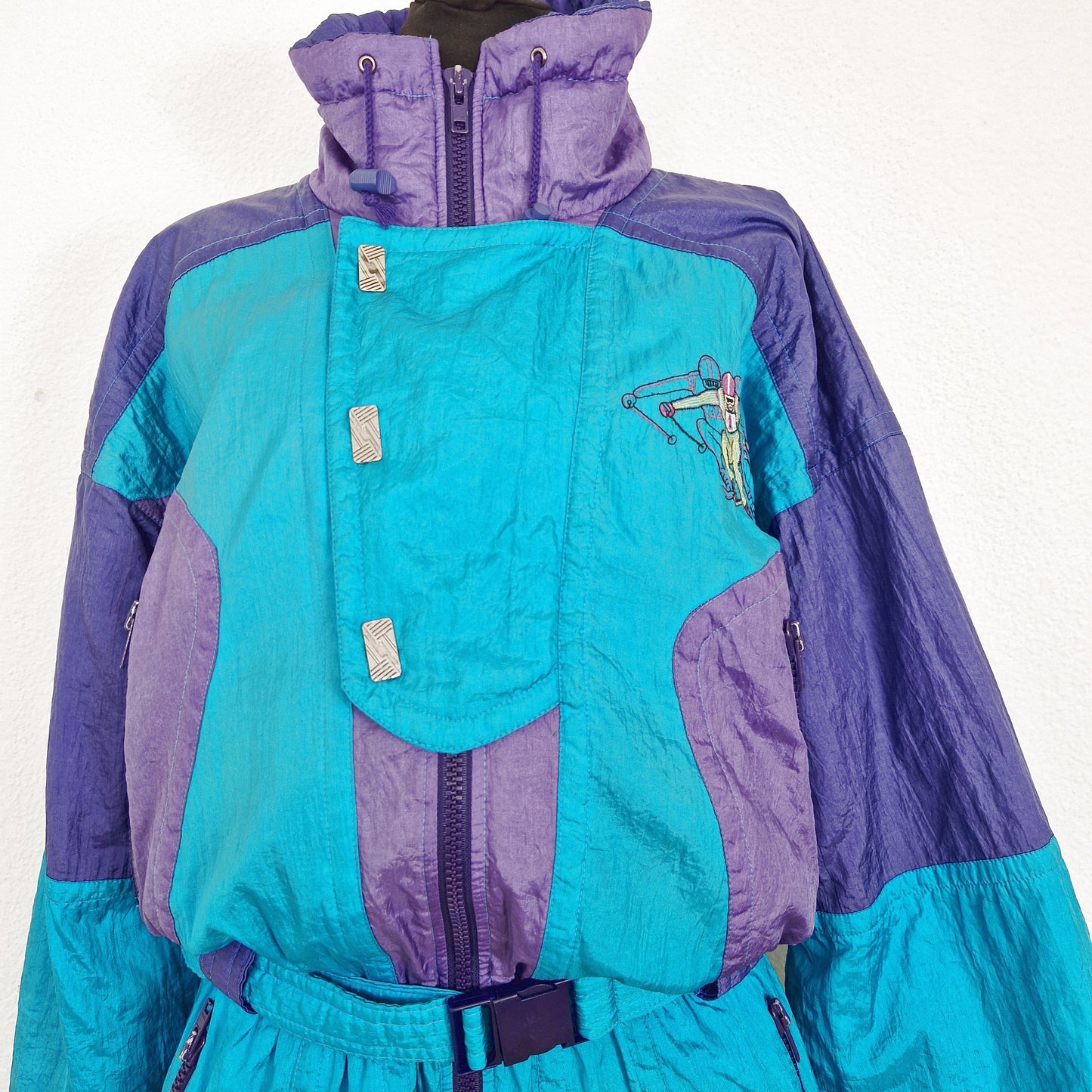 Einzigartiger und nachhaltiger Vintage Skianzug in türkis-violett. Unique and sustainable vintage ski suit in turquois-purple. Close-up 2.